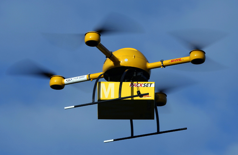An unmanned aerial vehicle (UAV) carries a parcel in Bonn, Germany, 09 December 2013. Deutsche Post DHL†has for the first time tested parcel deliveries with a drone. Photo by: Oliver Berg/picture-alliance/dpa/AP Images
