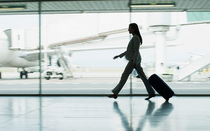 Businesswoman with suitcase in airport