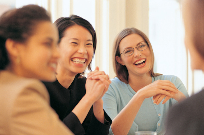 Businesswomen laughing in meeting