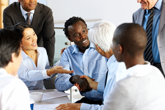 Successful businesspeople shaking hands making a necessary agreement during a meeting