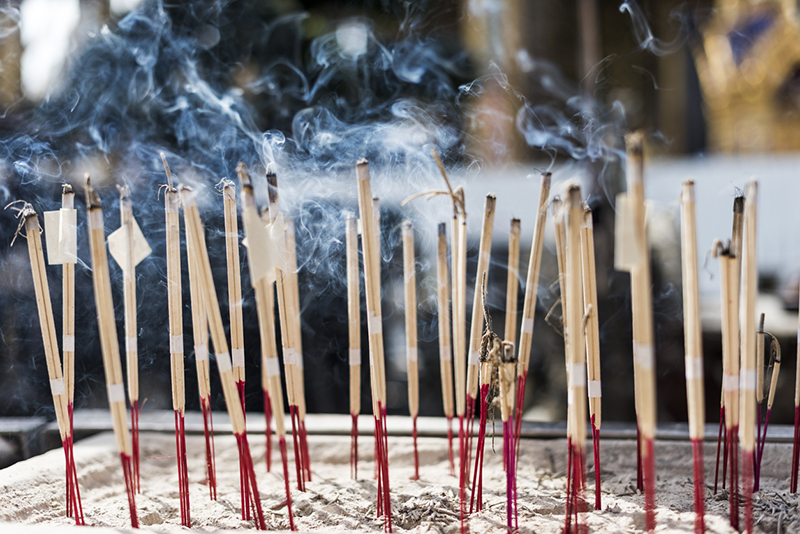 Burning incense sticks in Thai temple. Bangkok, Thailand.