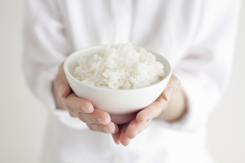Woman holding bowl of rice